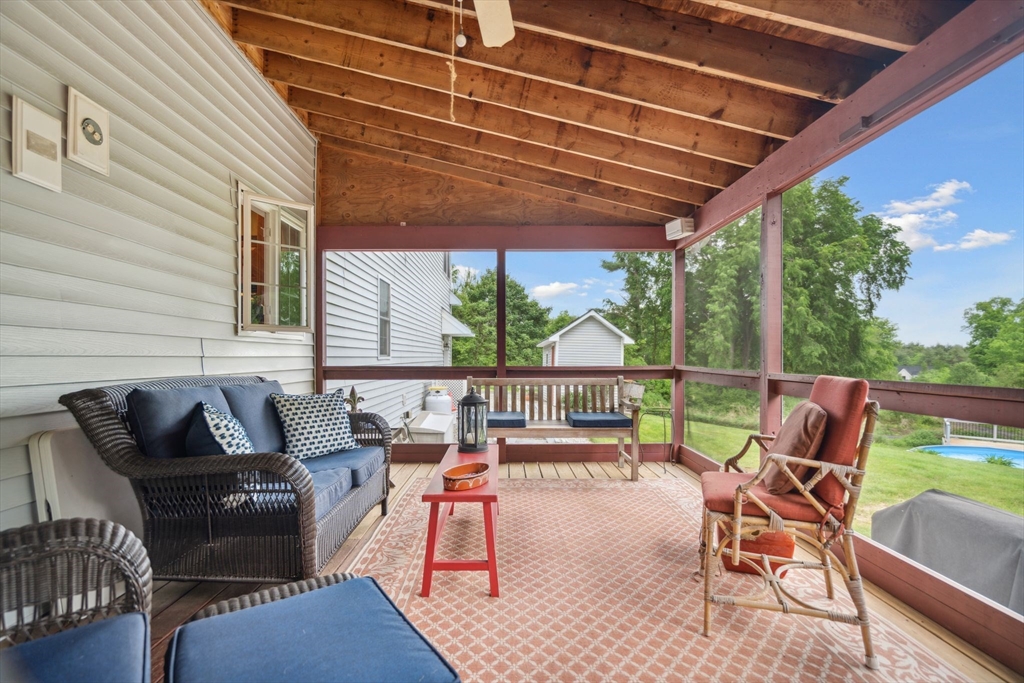 5 Maple Street Pepperell, MA 01463 - Photo 34 of 39 a roof deck with a table and chairs with wooden floor
