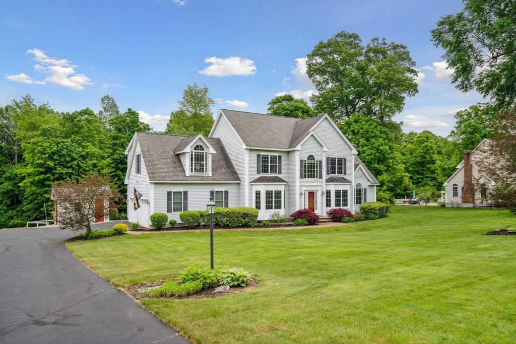 5 Maple Street Pepperell, MA 01463 - Photo 4 of 39 a front view of a house with a garden and trees
