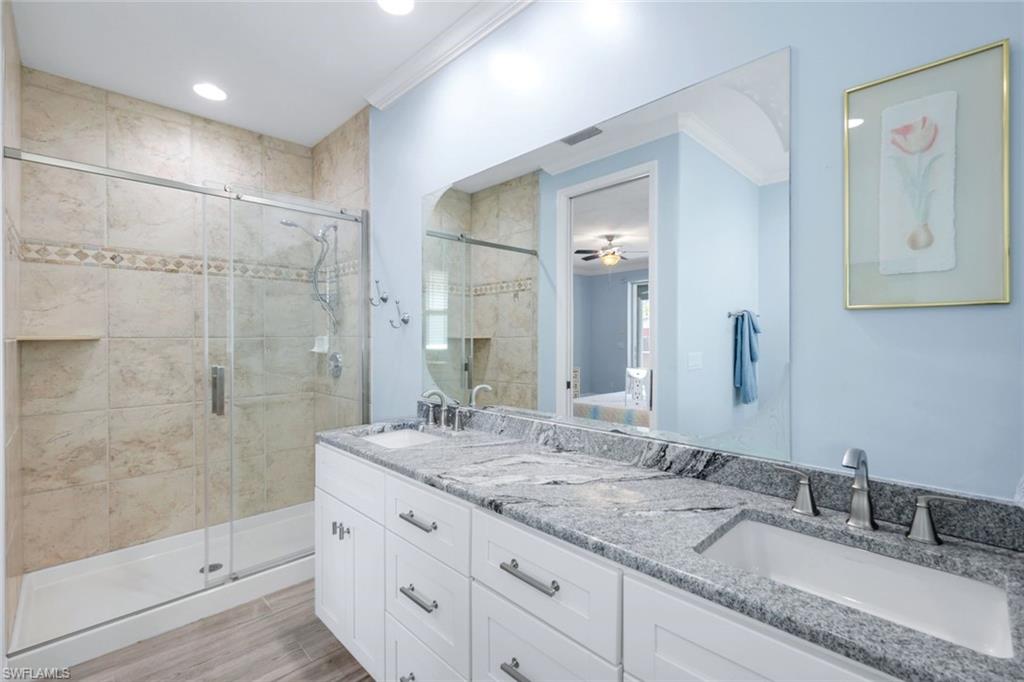 746 101st Avenue North Naples, FL 34108 - Photo 15 of 33 a bathroom with a granite countertop sink mirror and shower