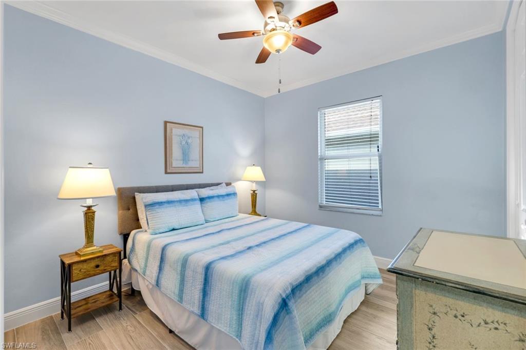 746 101st Avenue North Naples, FL 34108 - Photo 18 of 33 a bedroom with a bed and a lamp
