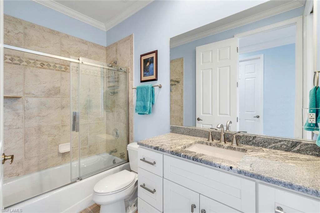 746 101st Avenue North Naples, FL 34108 - Photo 19 of 33 a bathroom with a granite countertop sink a toilet and shower