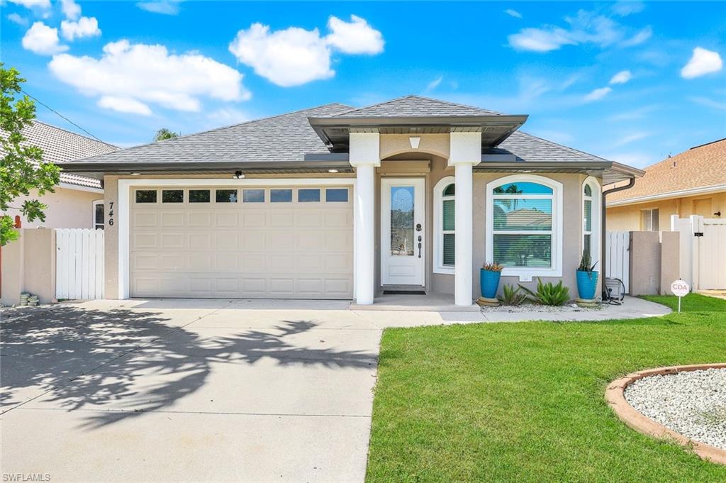746 101st Avenue North Naples, FL 34108 - Photo 2 of 33 a front view of a house with a yard