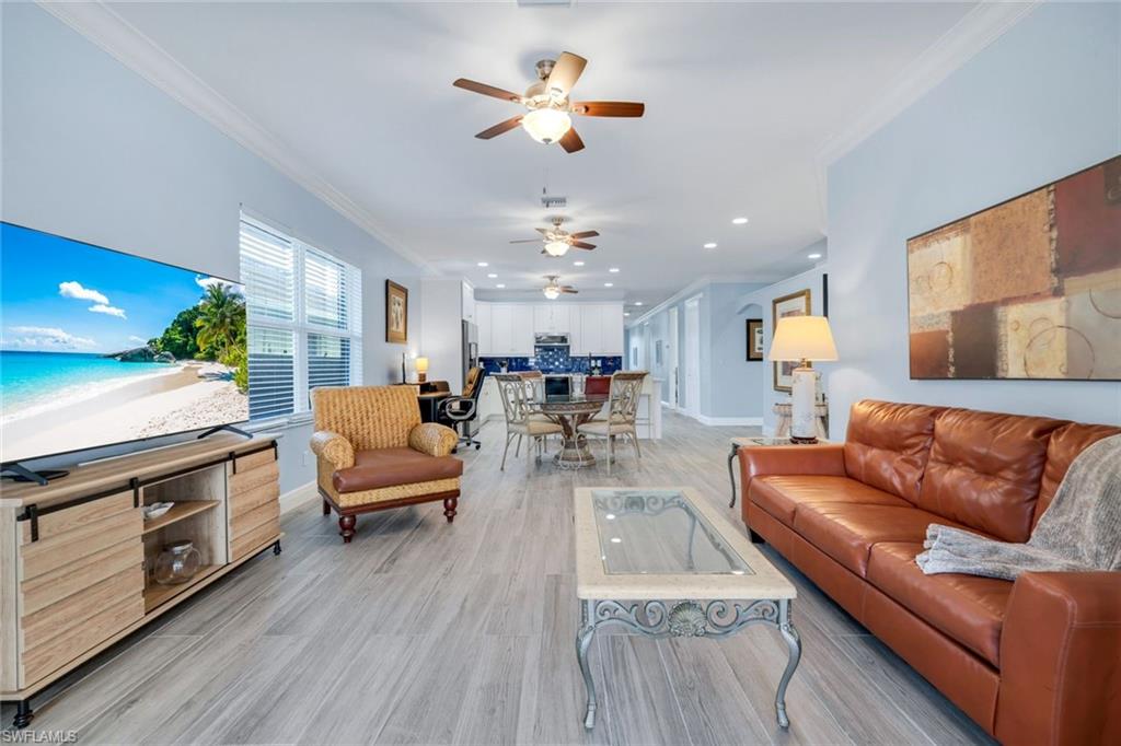 746 101st Avenue North Naples, FL 34108 - Photo 10 of 33 a living room with furniture fireplace and wooden floor