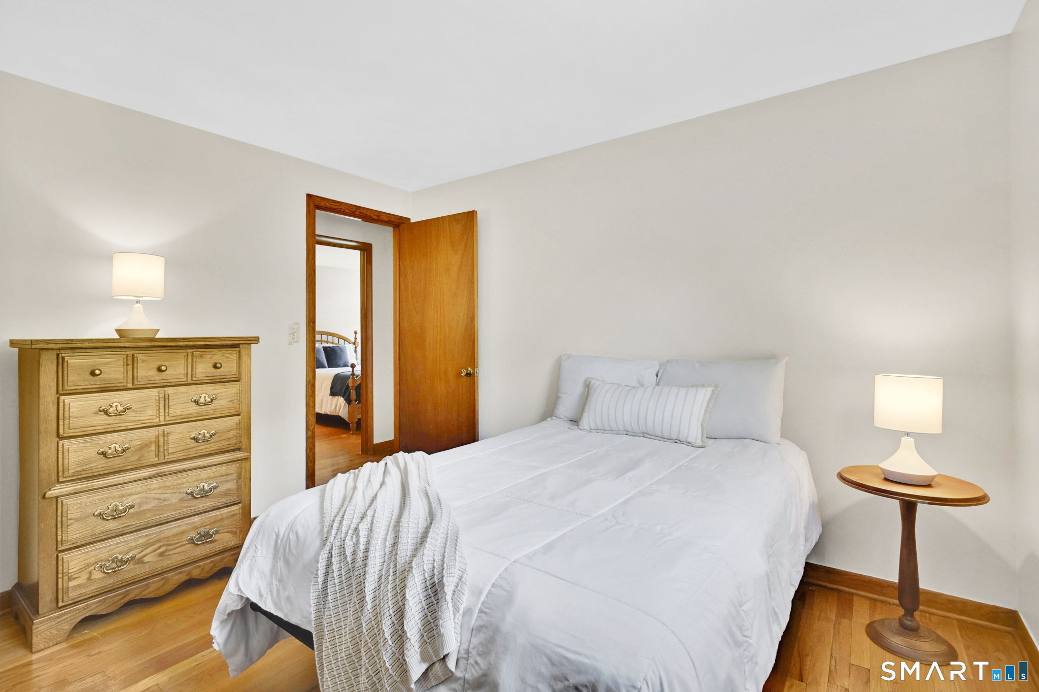 296 Phoenix Street Vernon, CT 06066 - Photo 16 of 34 a bedroom with a bed and a lamp with the dresser