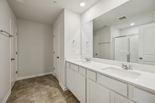 a bathroom with a sink double vanity and a mirror