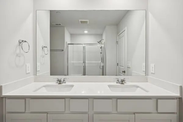 a bathroom with a sink double vanity and a mirror