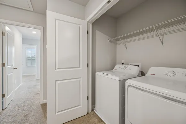 a view of storage and utility room with washer and dryer