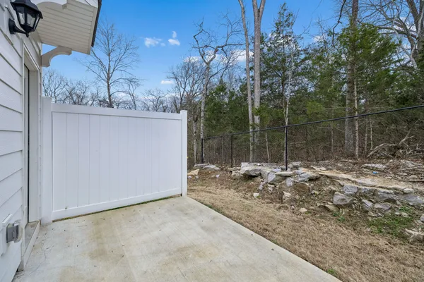 a backyard of a house with table and chairs