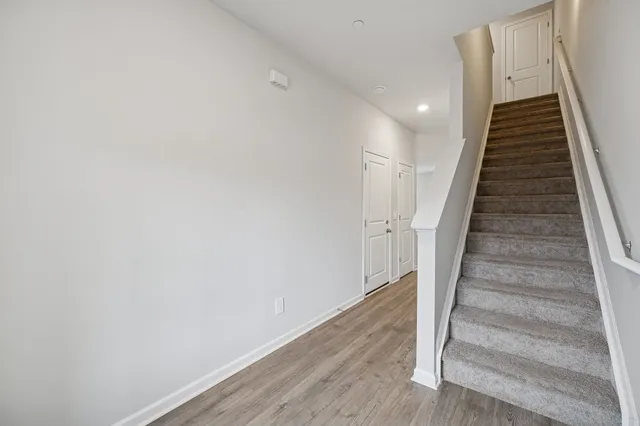 a view of entryway and hall with wooden floor