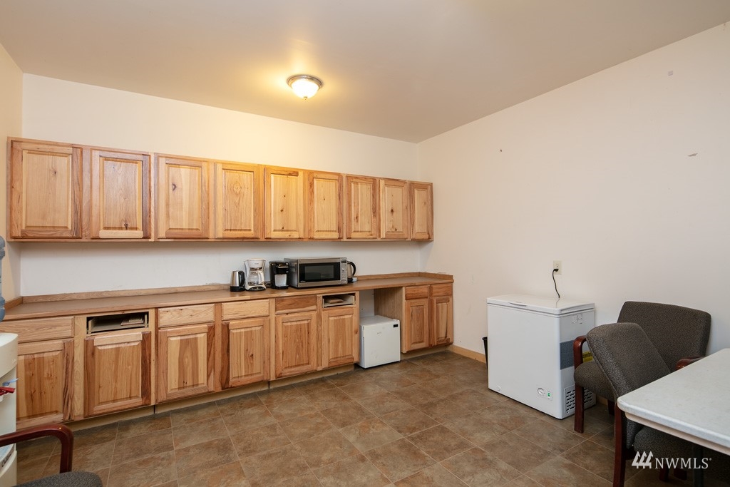 5435 Sand Road Bellingham, WA 98226 - Photo 12 of 38 a kitchen with cabinets and chairs