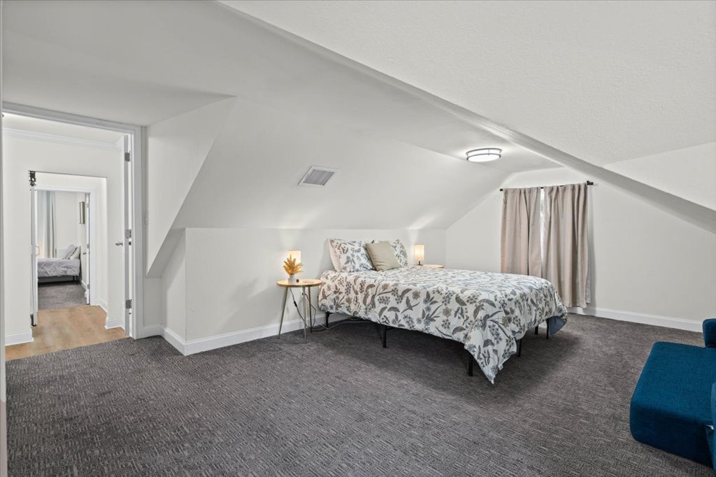 1201 Garden Street, Unit A Austin, TX 78702 - Photo 23 of 30 Carpeted room with sloped ceilings, white walls, and recessed lighting
