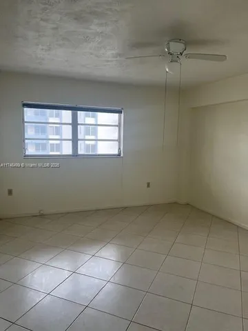 an empty room with a empty space and window