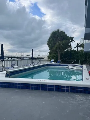 a view of a swimming pool with a yard