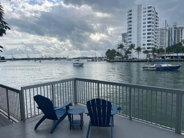 a view of roof deck with chairs and barbeque grill
