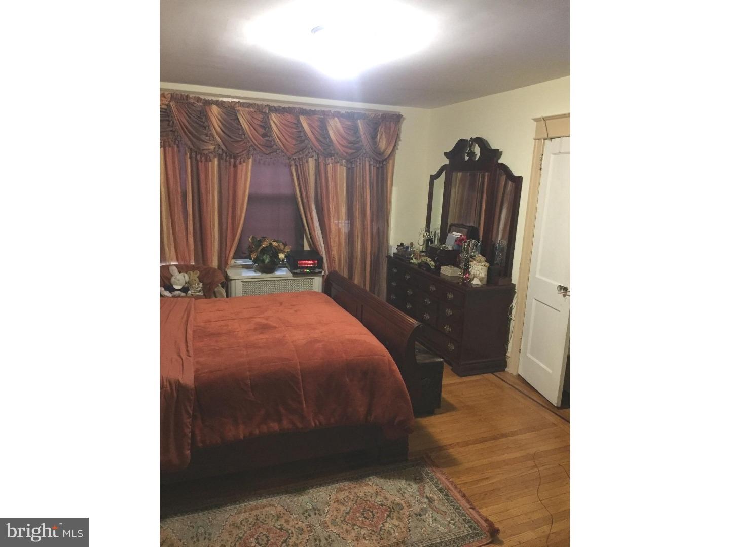 525 Holly Road Yeadon, PA 19050 - Photo 18 of 25 a bedroom with a bed and a chandelier