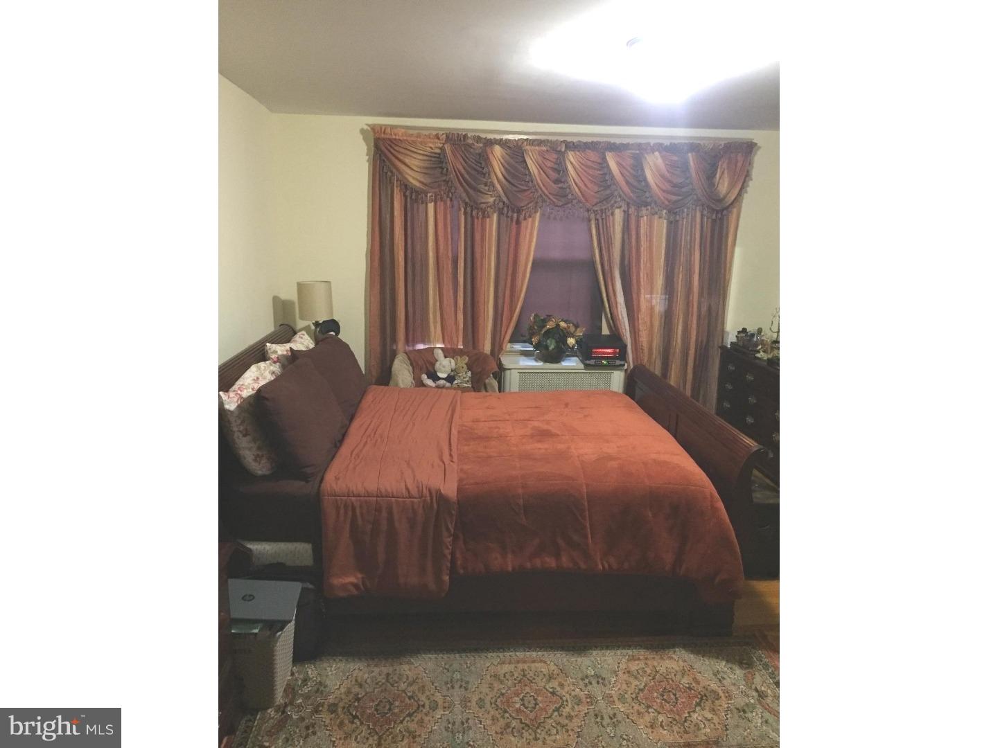 525 Holly Road Yeadon, PA 19050 - Photo 20 of 25 a bed sitting in a bedroom next to a window