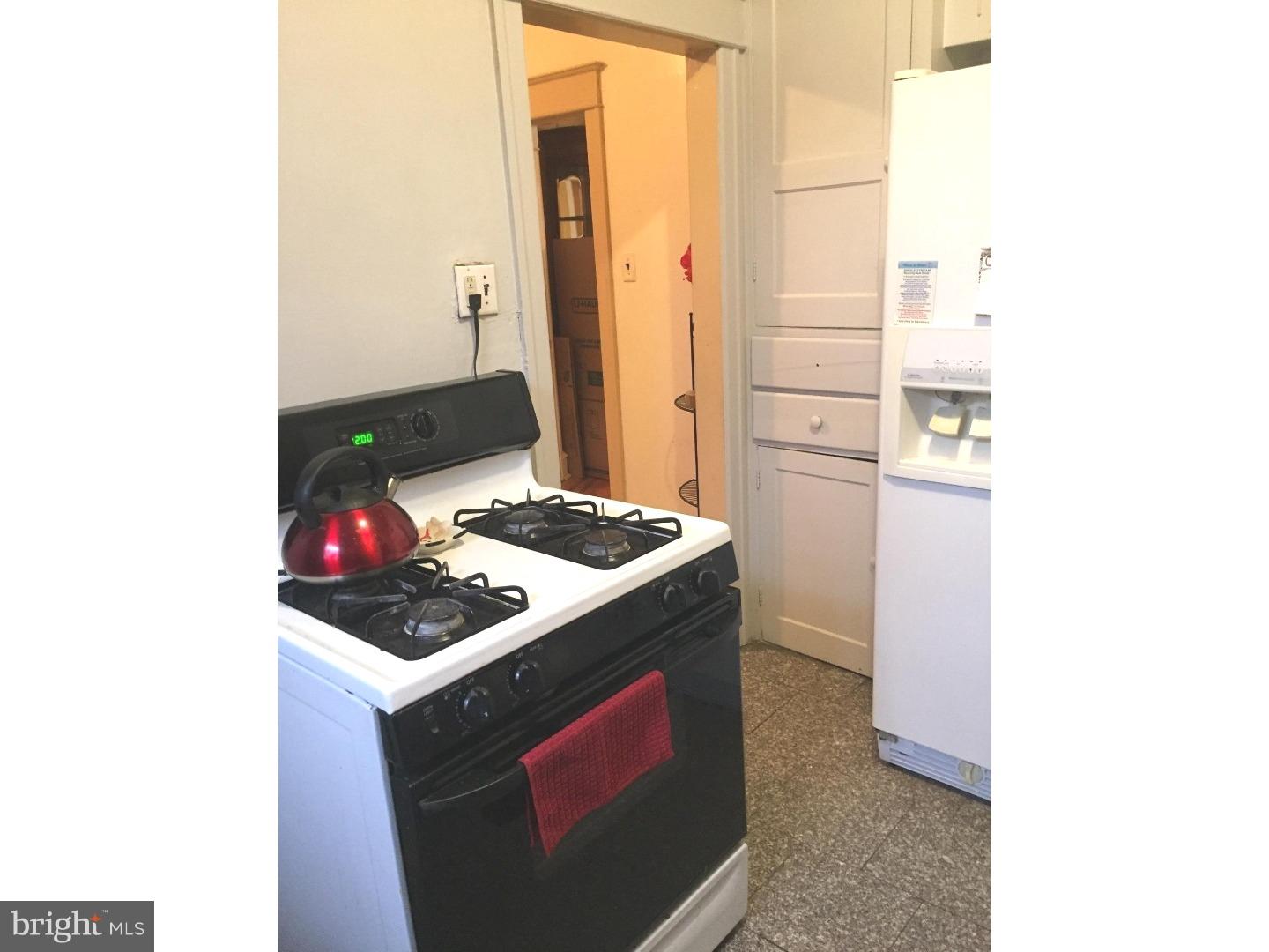 525 Holly Road Yeadon, PA 19050 - Photo 7 of 25 a kitchen that has a sink and a stove in it