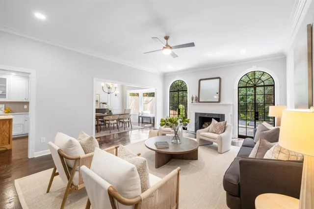 a living room with furniture fireplace and a large window