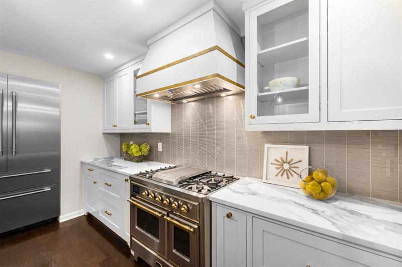 650 Moores Mill Road Northwest, Unit 11 Atlanta, GA 30327 - Photo 11 of 31 a kitchen with a stove and a cabinets