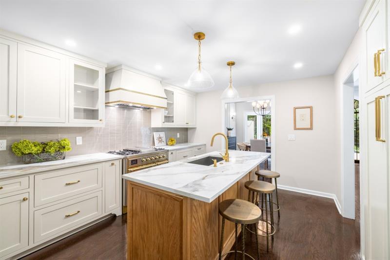 650 Moores Mill Road Northwest, Unit 11 Atlanta, GA 30327 - Photo 13 of 31 a kitchen that has a lot of cabinets in it and wooden floors