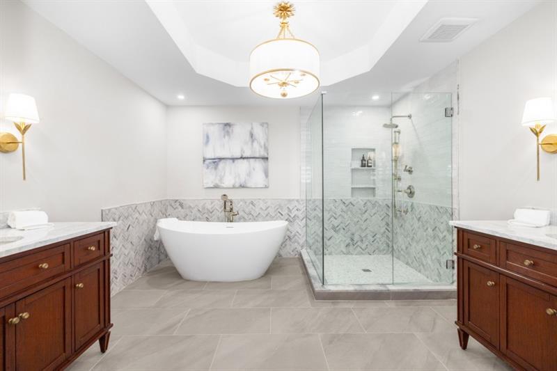 650 Moores Mill Road Northwest, Unit 11 Atlanta, GA 30327 - Photo 20 of 31 a spacious bathroom with a bathtub shower sink mirror and vanity