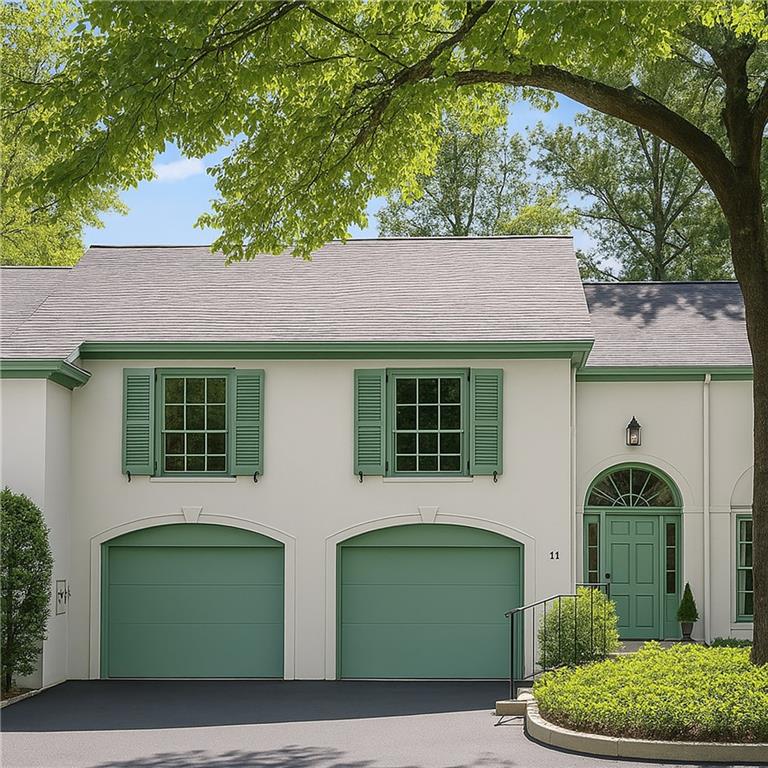 650 Moores Mill Road Northwest, Unit 11 Atlanta, GA 30327 - Photo 2 of 31 a front view of a house with garden