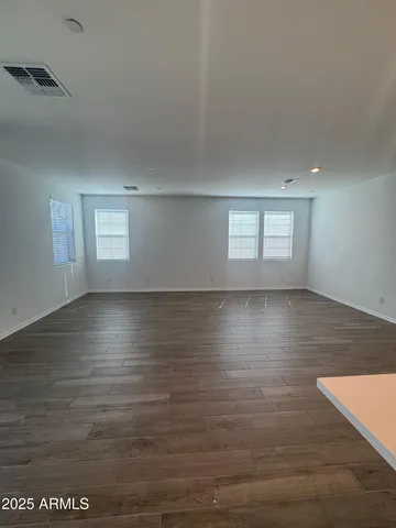 a view of room with window and wooden floor