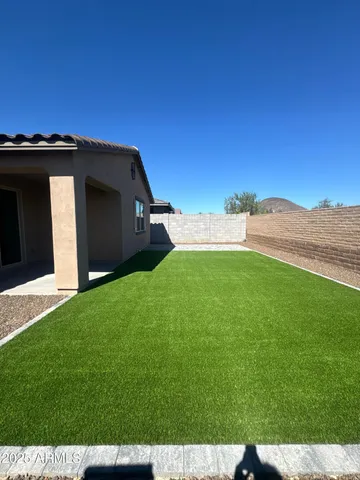 a view of a wooden house with a yard