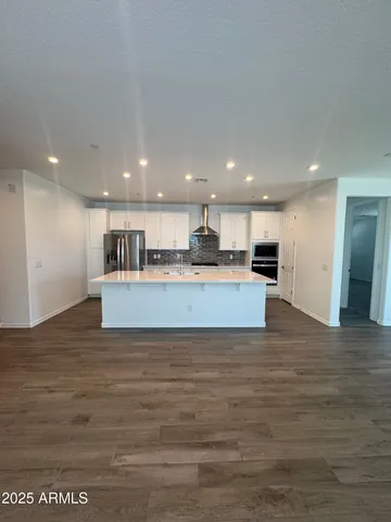 a view of kitchen with kitchen island microwave and refrigerator