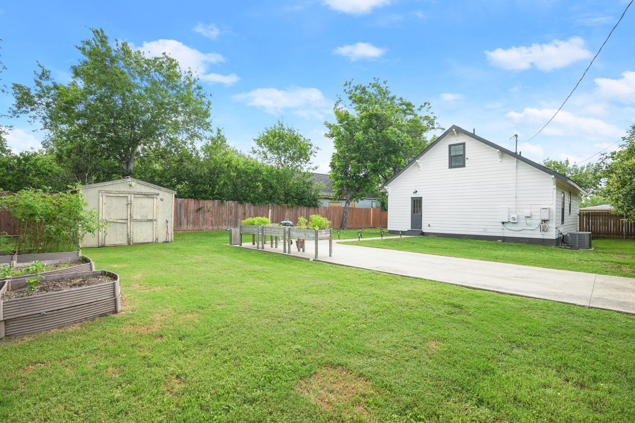 301 Old Thorndale Road Taylor, TX 76574 - Photo 26 of 29 A spacious yard with mature trees and a long driveway leads to the rear of the residence.