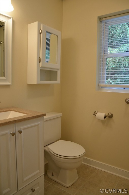 4940 Windsor Road Sandston, VA 23150 - Photo 18 of 22 a bathroom with a toilet a sink and a window