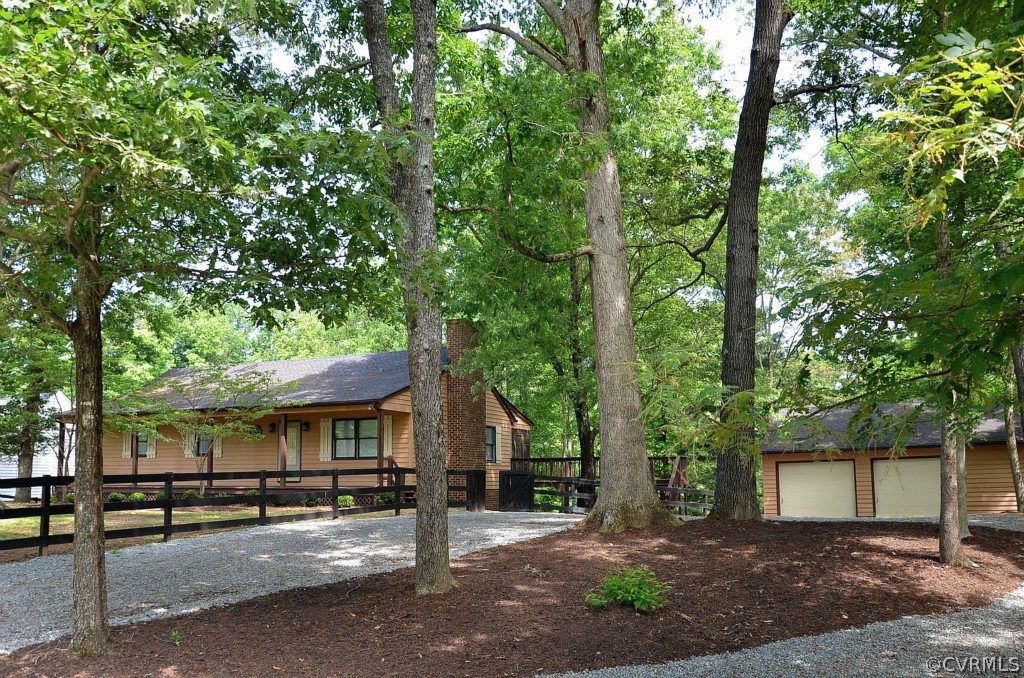 4940 Windsor Road Sandston, VA 23150 - Photo 3 of 22 a view of a house with a tree and wooden fence