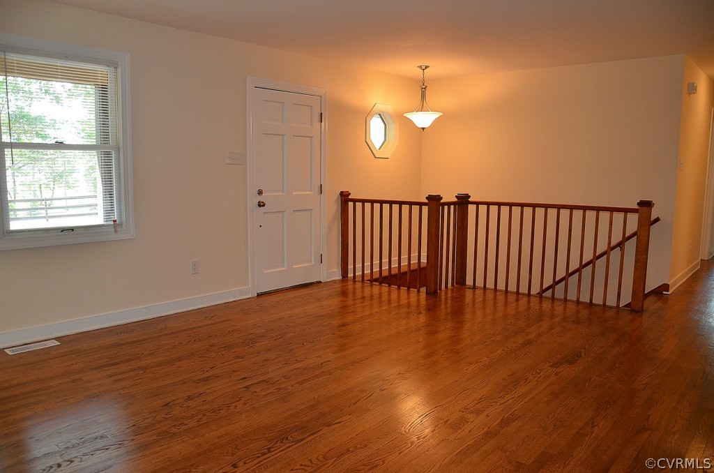 4940 Windsor Road Sandston, VA 23150 - Photo 4 of 22 an empty room with wooden floor and windows