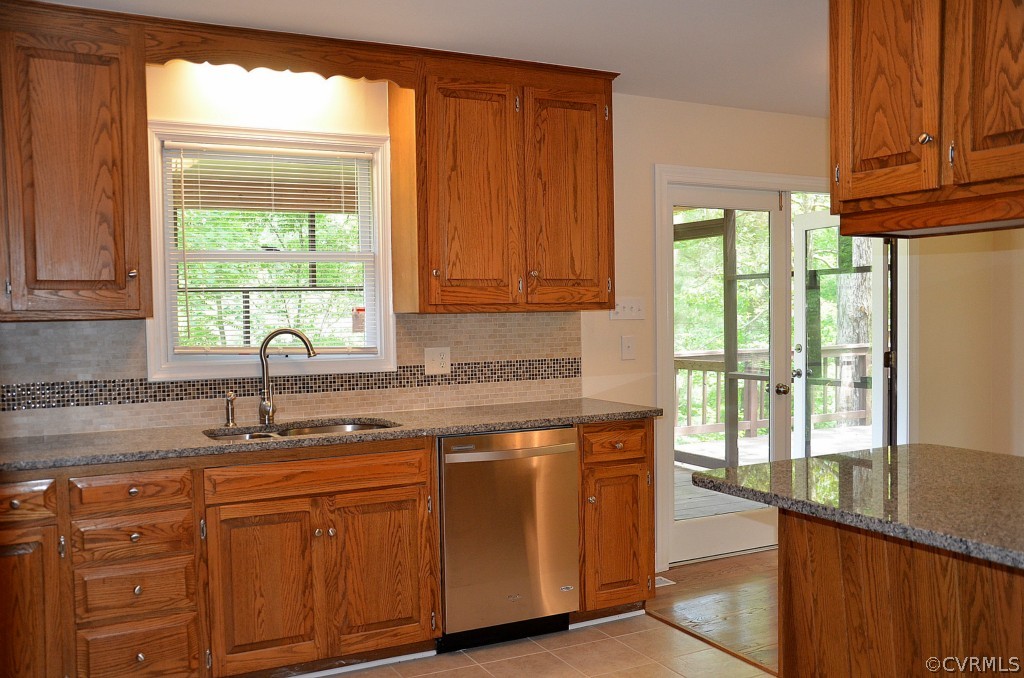 4940 Windsor Road Sandston, VA 23150 - Photo 7 of 22 a kitchen with stainless steel appliances granite countertop a sink a window and a counter space