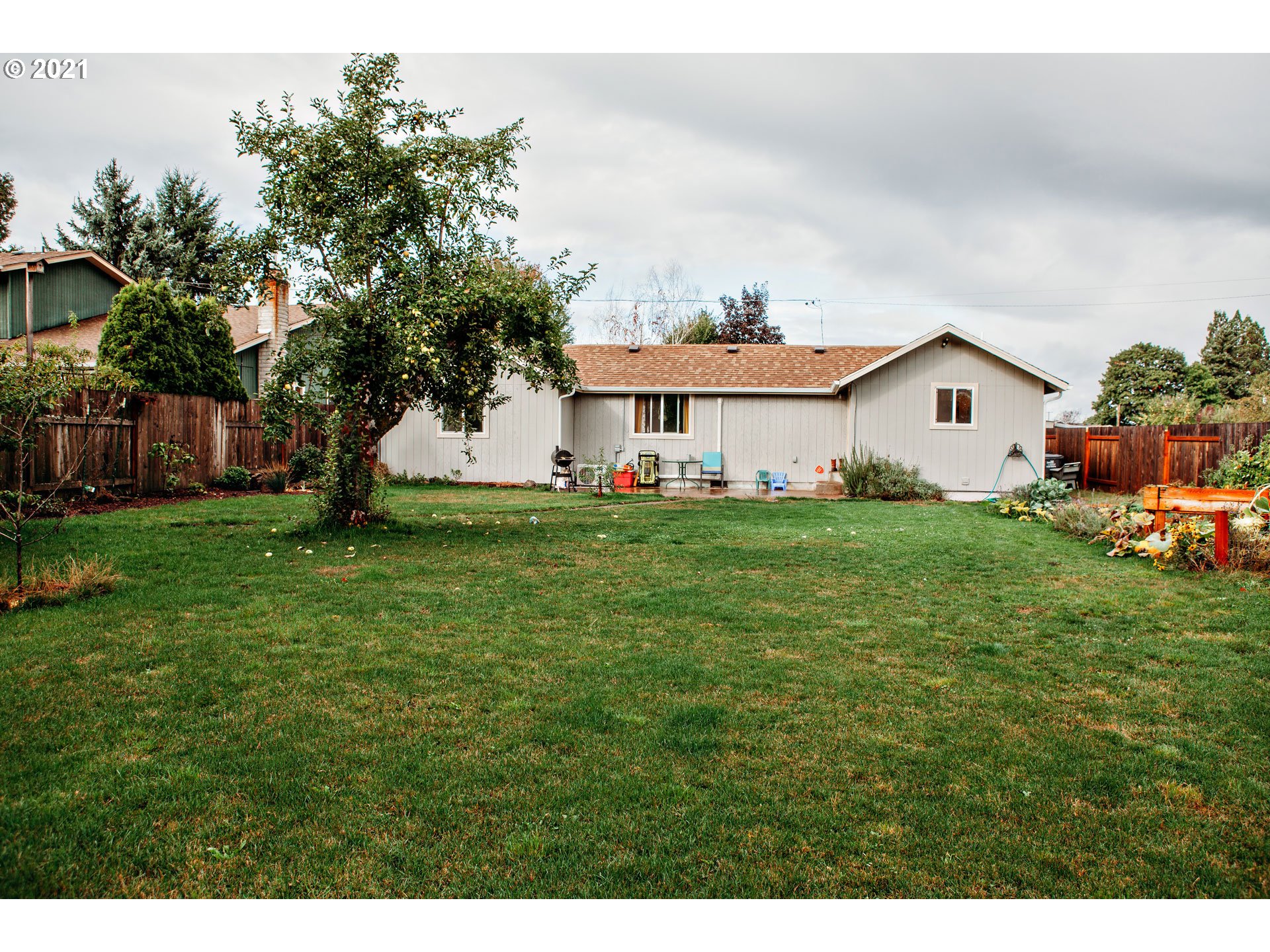 577 South 35th Street Springfield, OR 97478 - Photo 13 of 14 a front view of a house with a yard and trees