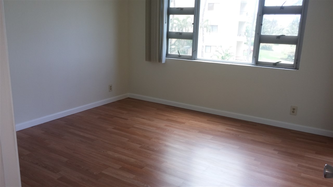 760 South Kihei Road, Unit 225 Kihei, HI 96753 - Photo 8 of 14 an empty room with wooden floor and windows