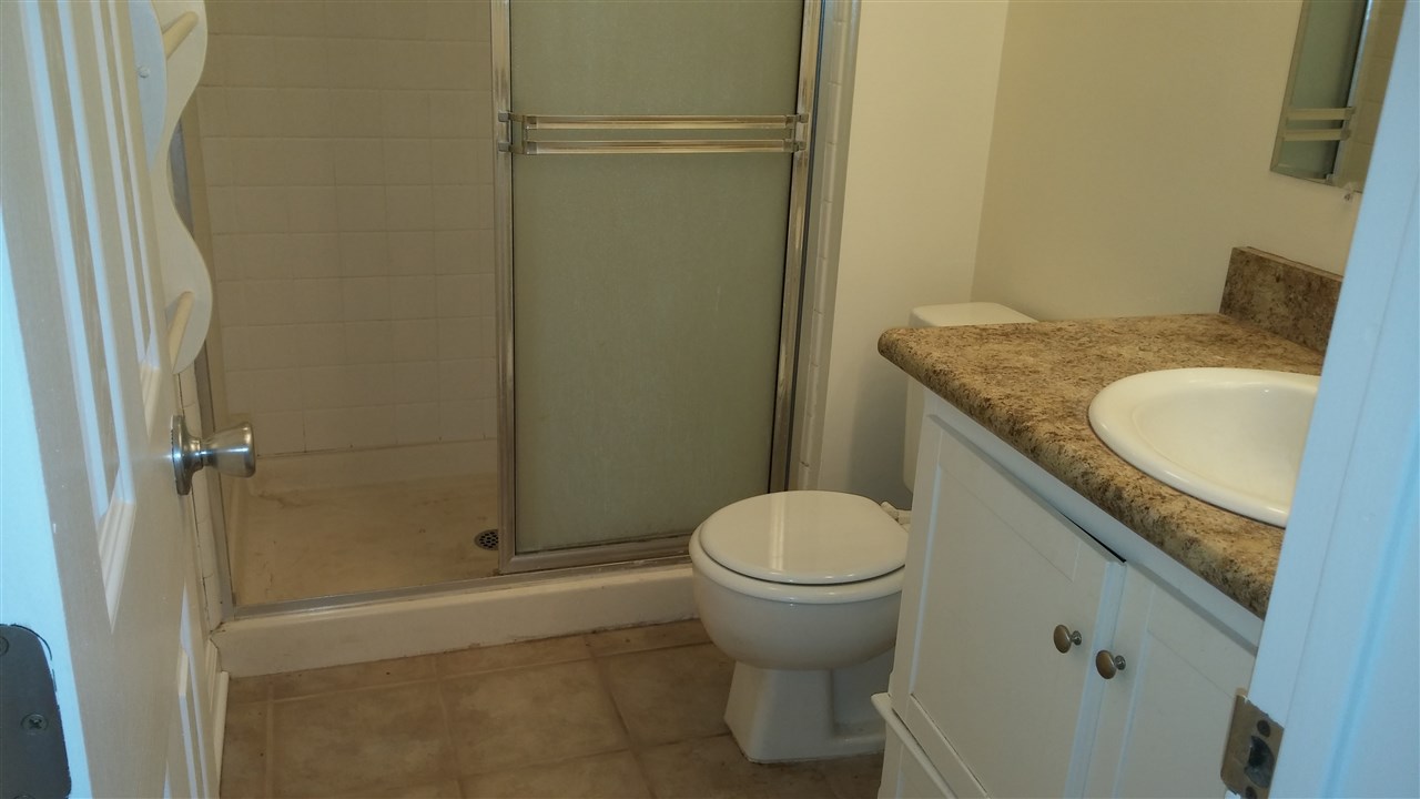 760 South Kihei Road, Unit 225 Kihei, HI 96753 - Photo 9 of 14 a bathroom with a granite countertop sink toilet and shower