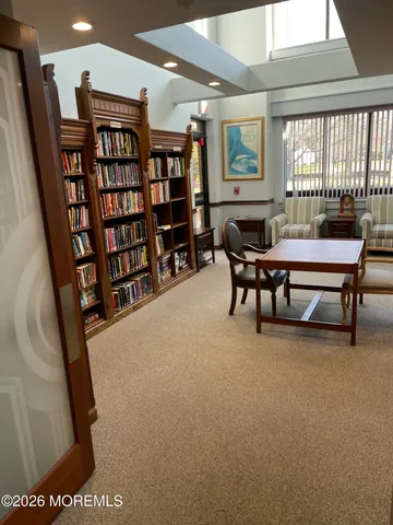 a living room with furniture a flat screen tv and bookshelf