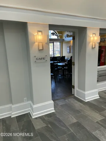 a view of a hallway and dining room with a mirror