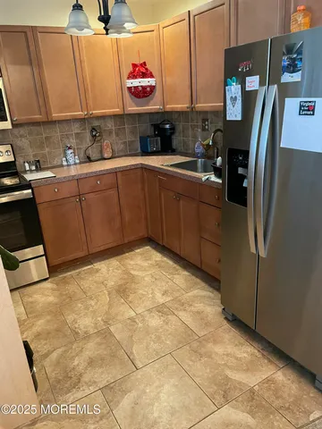 a kitchen with stainless steel appliances a sink and a refrigerator