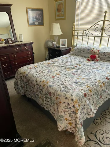 a bedroom with a bed and a dresser