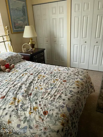 a bedroom with a bed and a mirror
