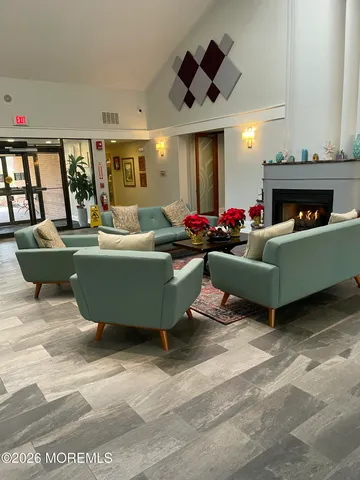 a living room with furniture a fireplace and a large window