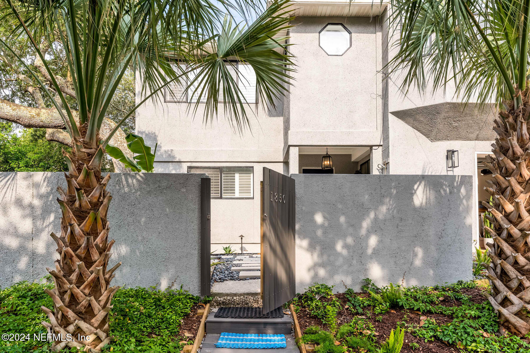1850 Beach Avenue Atlantic Beach, FL 32233 - Photo 2 of 52 a front view of a house with a yard and potted plants