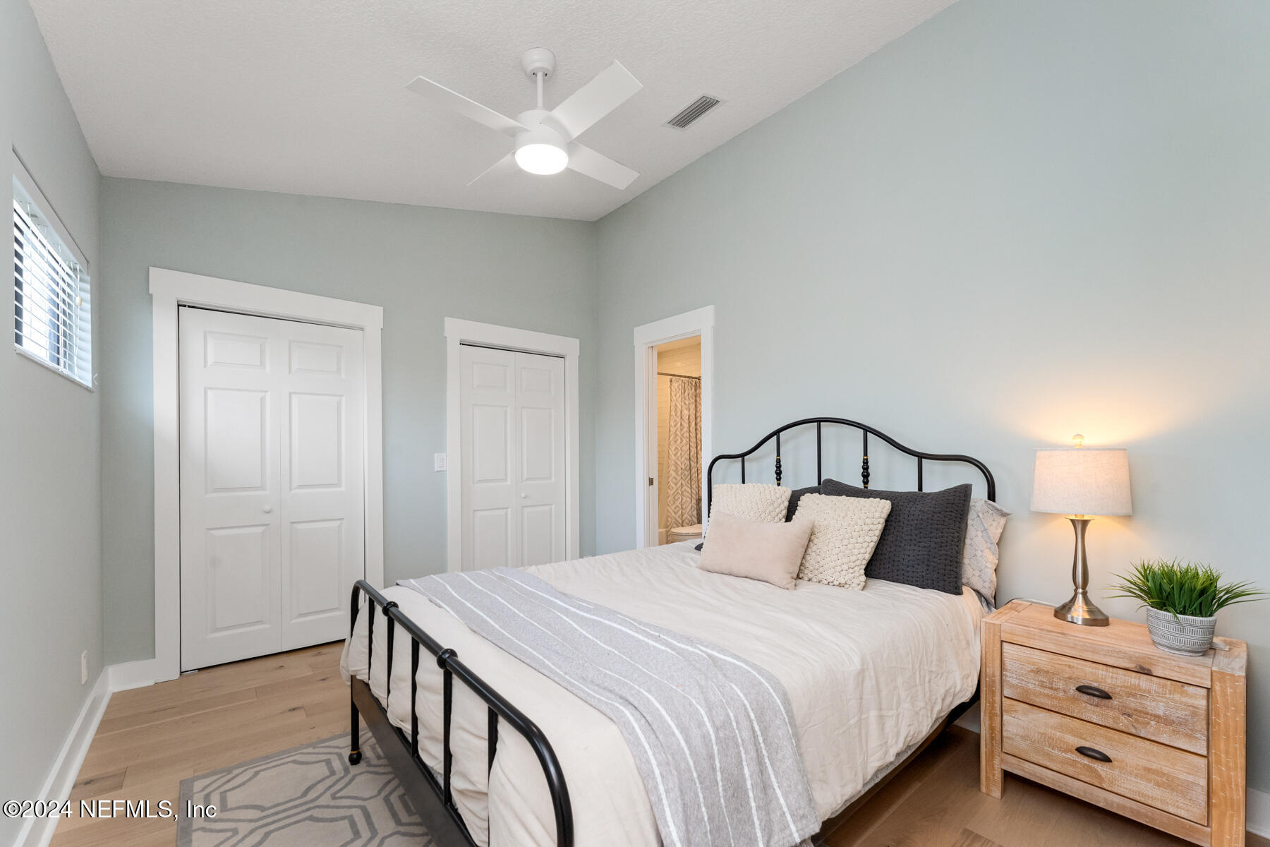 1850 Beach Avenue Atlantic Beach, FL 32233 - Photo 33 of 52 a bedroom with a bed and a lamp on dresser