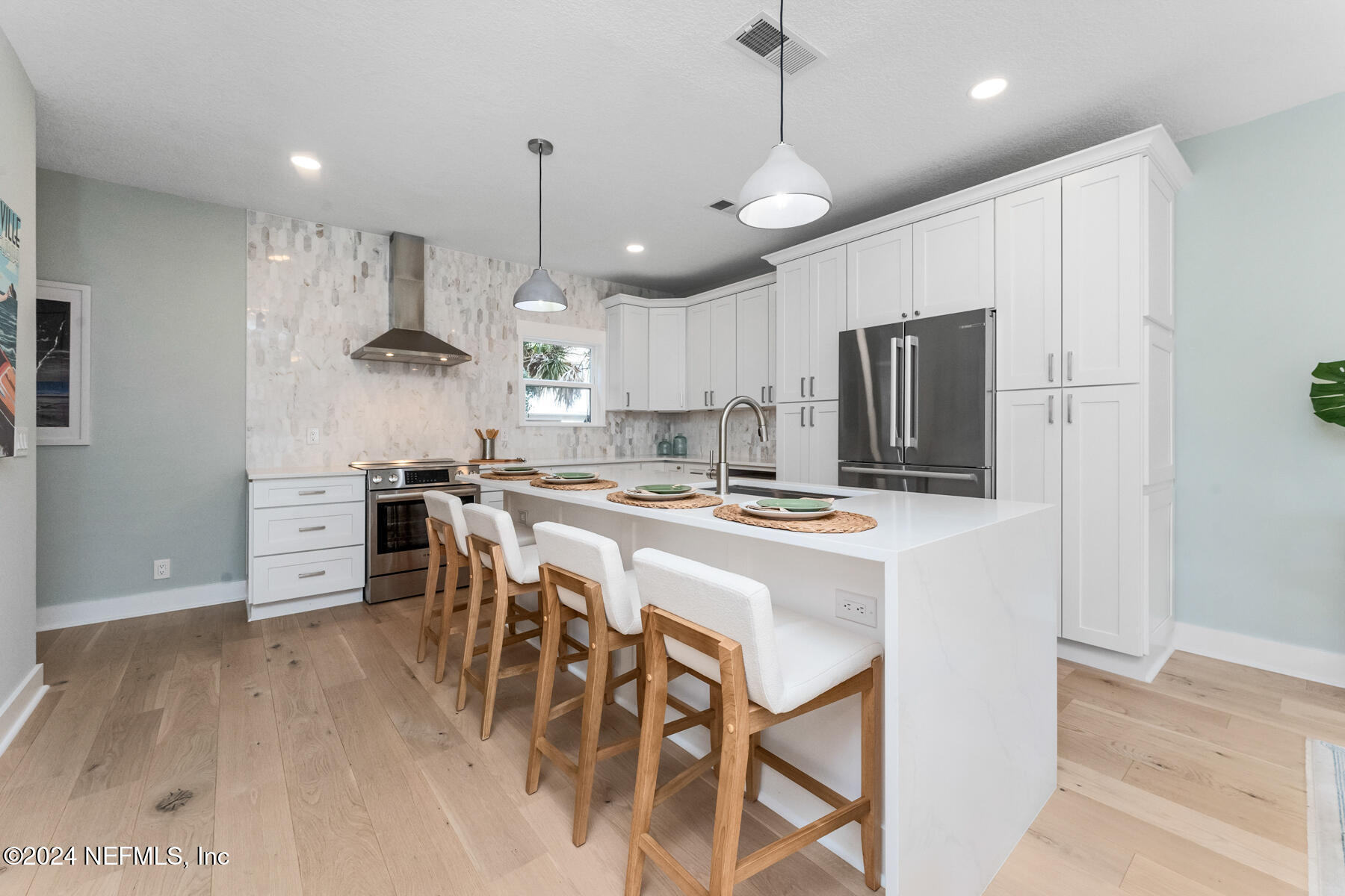 1850 Beach Avenue Atlantic Beach, FL 32233 - Photo 5 of 52 a kitchen with kitchen island a dining table chairs stainless steel appliances and cabinets