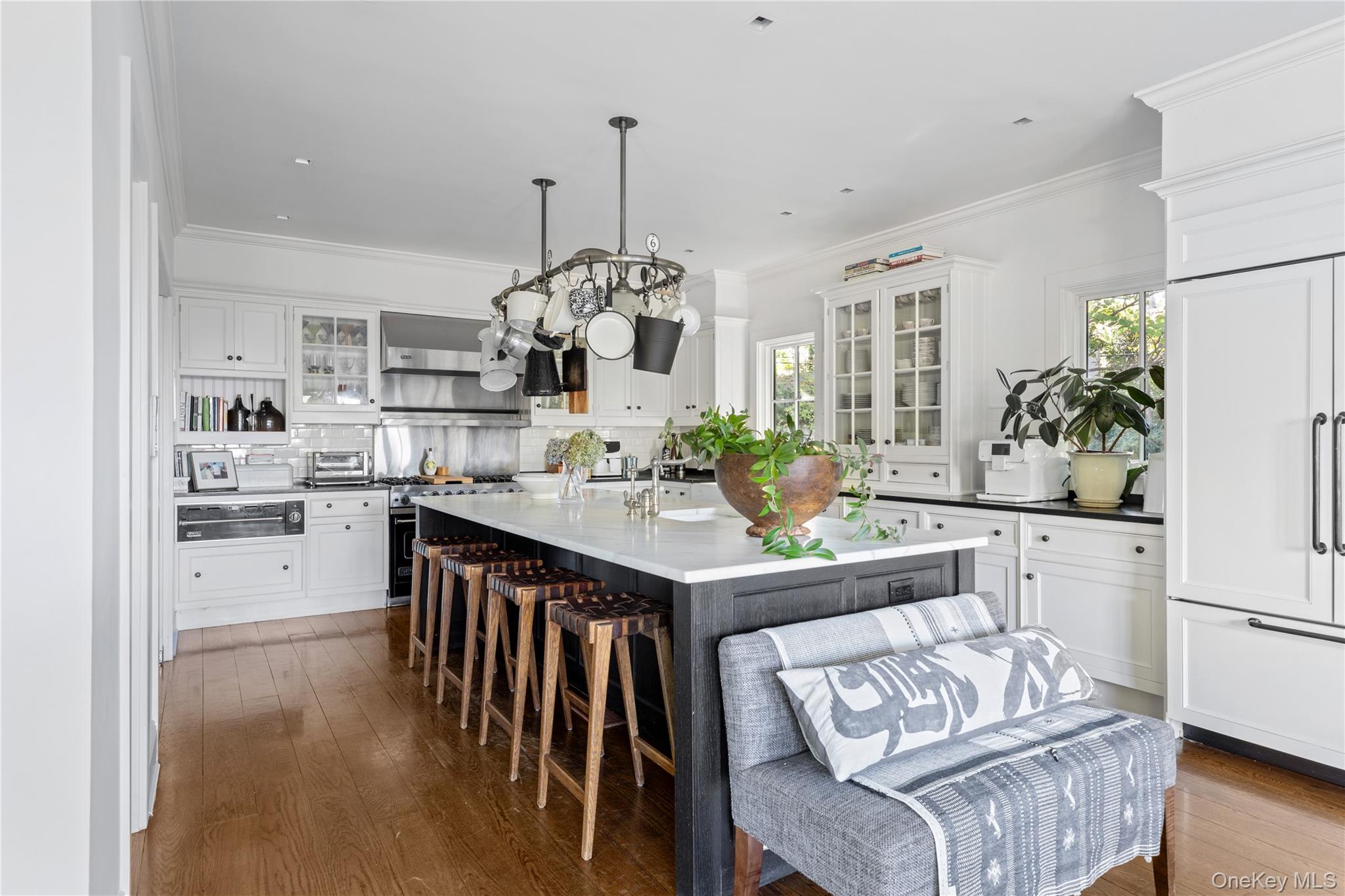 25 Soundview Lane Sands Point, NY 11050 - Photo 12 of 43 a kitchen with stainless steel appliances kitchen island granite countertop a table and chairs in it