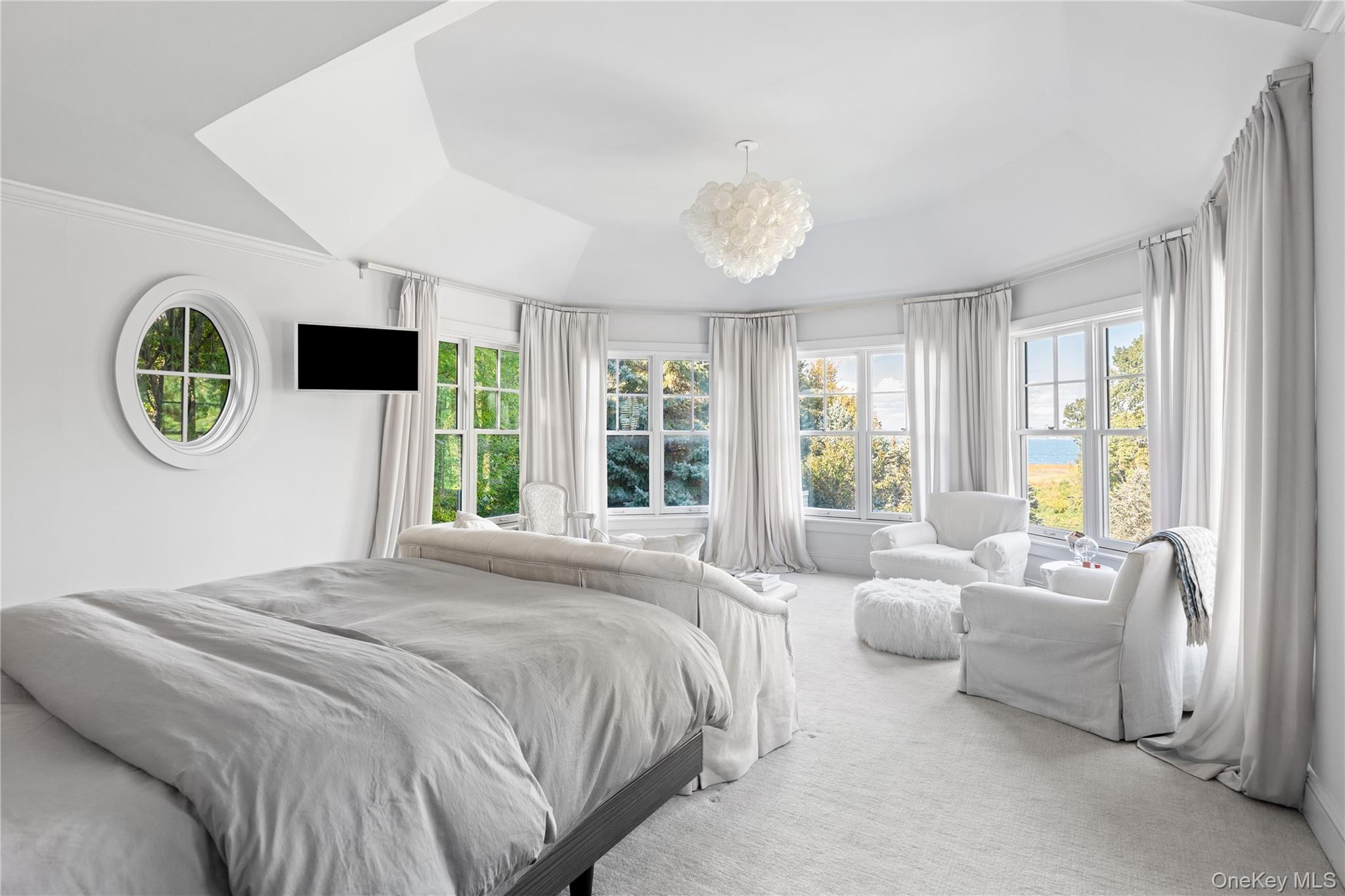 25 Soundview Lane Sands Point, NY 11050 - Photo 19 of 43 a spacious bedroom with a bed and a large window