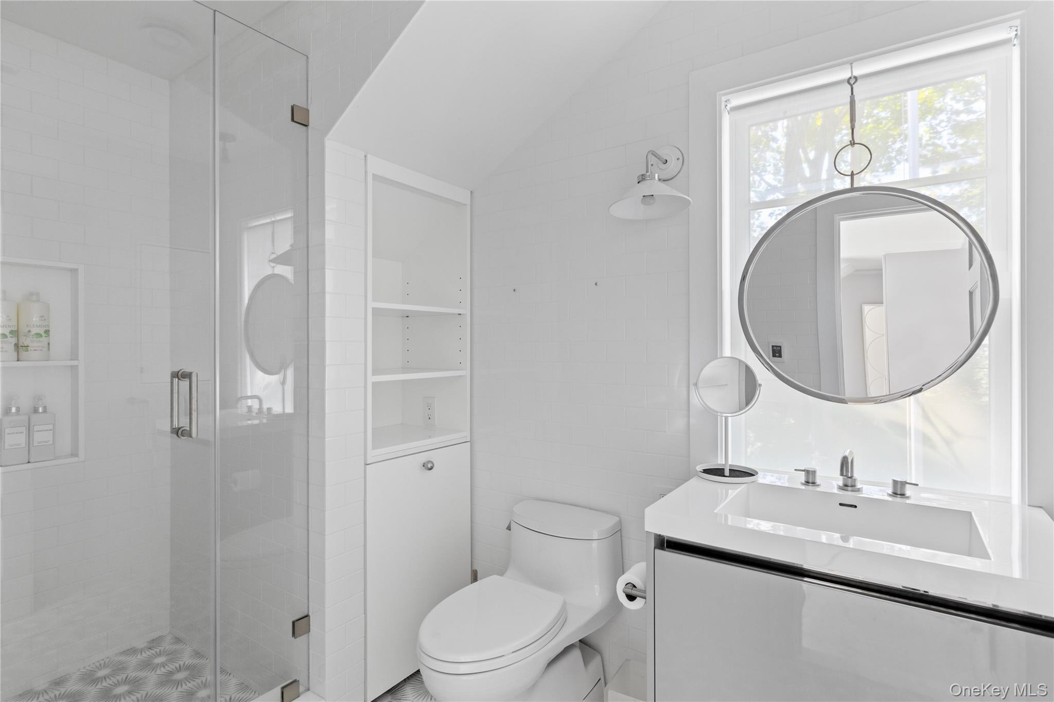 25 Soundview Lane Sands Point, NY 11050 - Photo 25 of 43 a bathroom with a toilet sink a mirror and shower