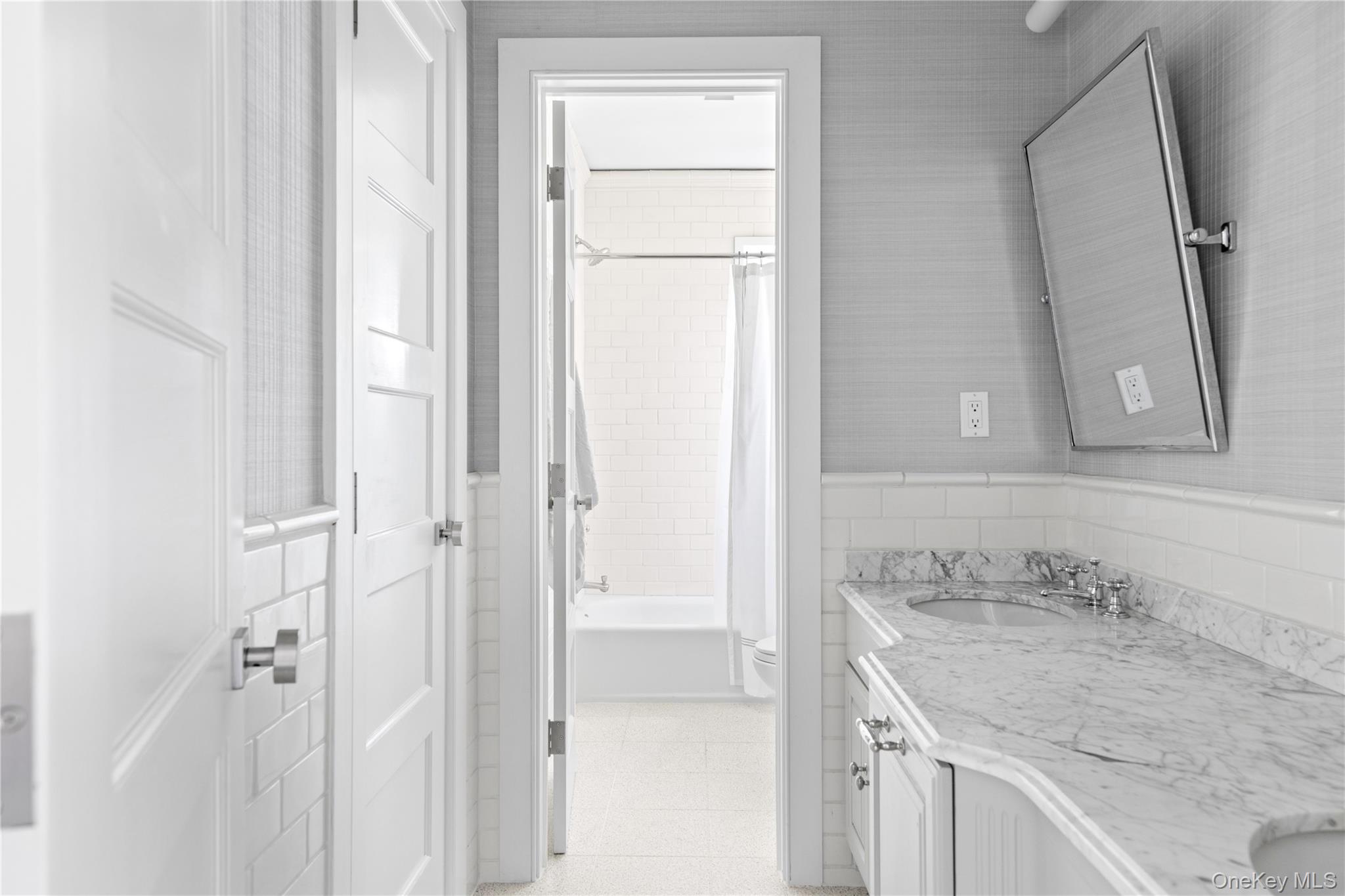 25 Soundview Lane Sands Point, NY 11050 - Photo 27 of 43 a bathroom with a granite countertop sink and a mirror
